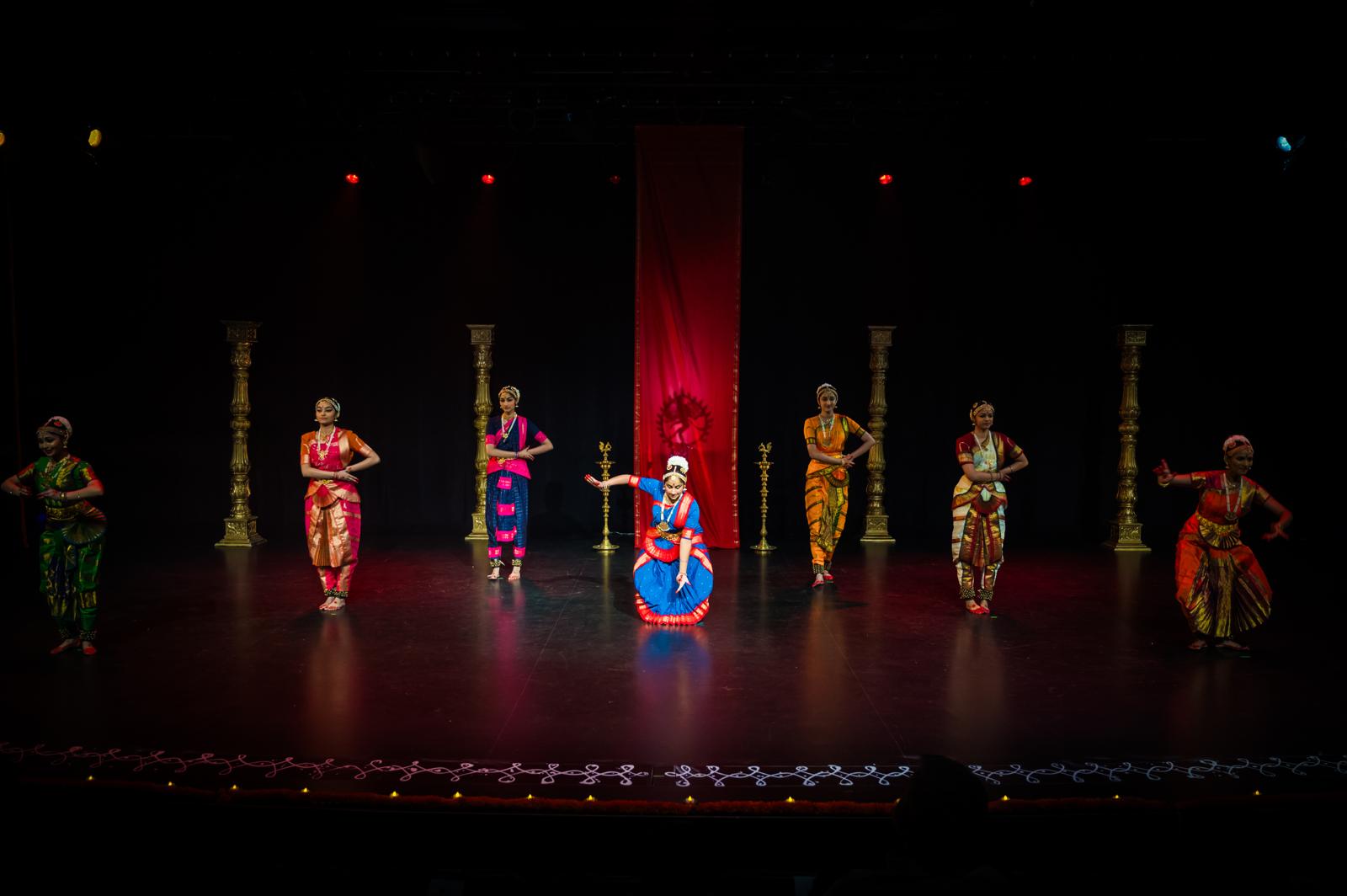 Rathi School of Dance performers dancing on a dark stage